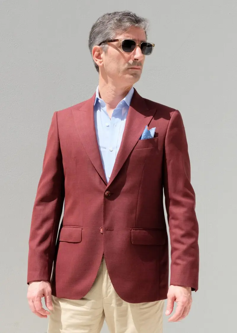 A man in sunglasses and a red jacket.