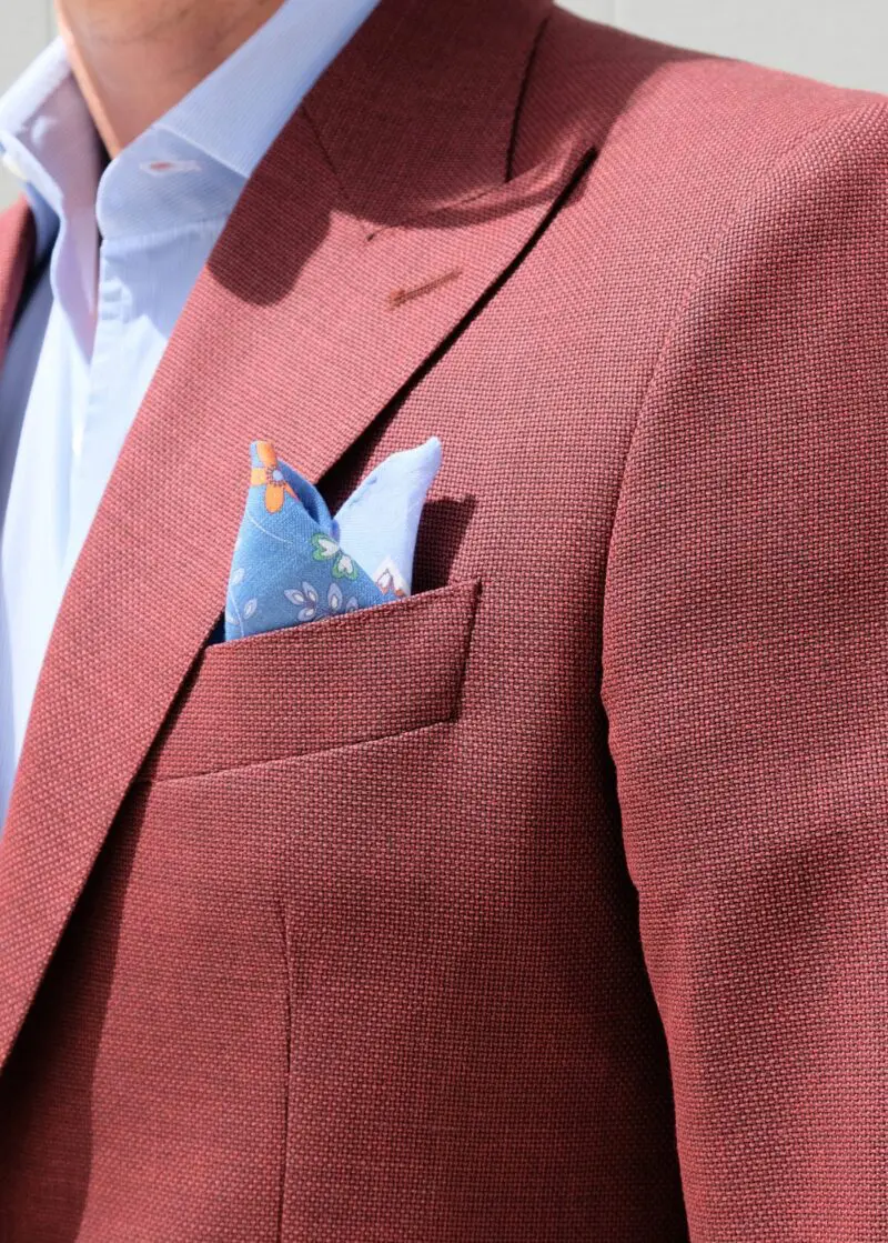 A man in a suit and tie with a pocket square.