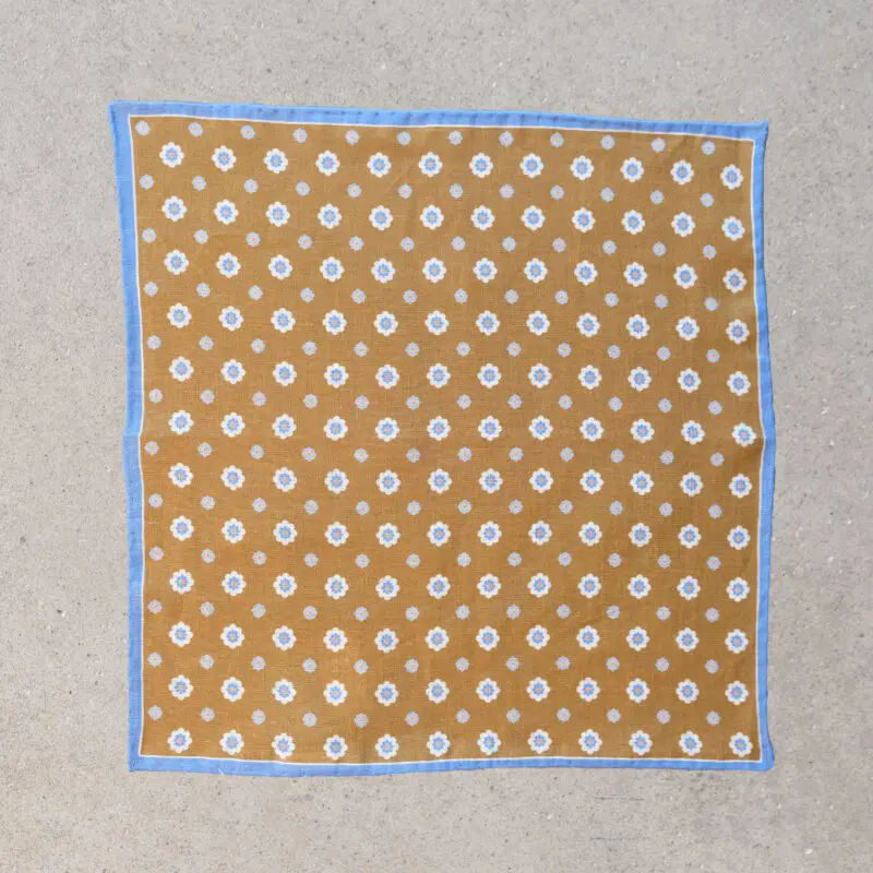 A brown and white polka dot cloth on the floor.