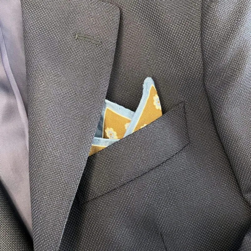 A close up of the pocket square in someone 's suit