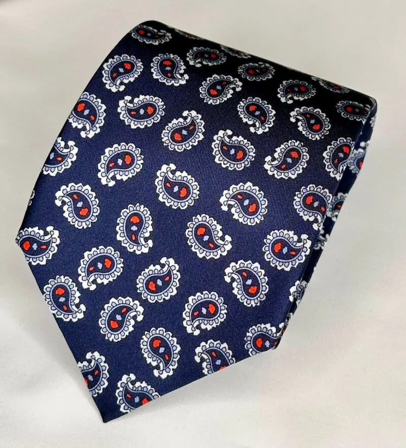 A blue tie with red and white paisley design.