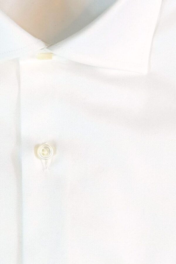 A white shirt with buttons on the collar and sleeves.