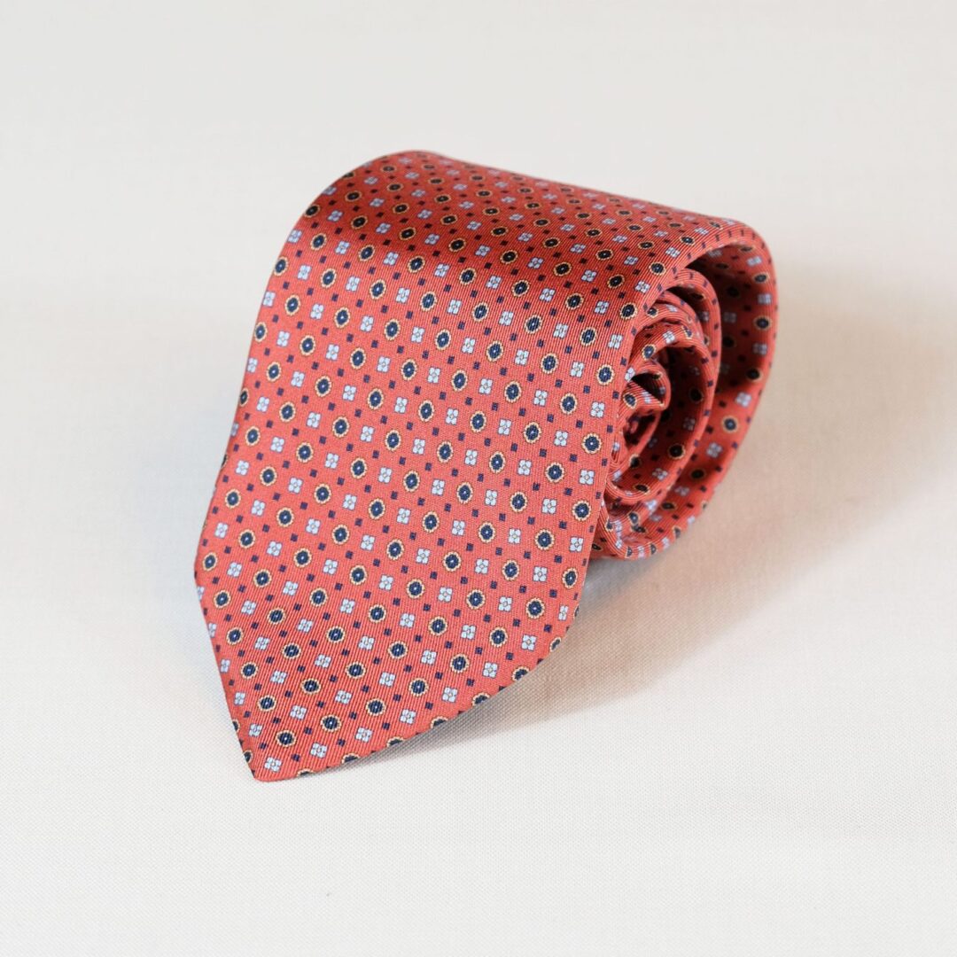 A red tie with blue and white squares on it
