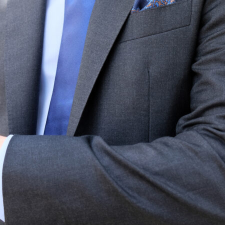 A close up of a person wearing a suit and tie