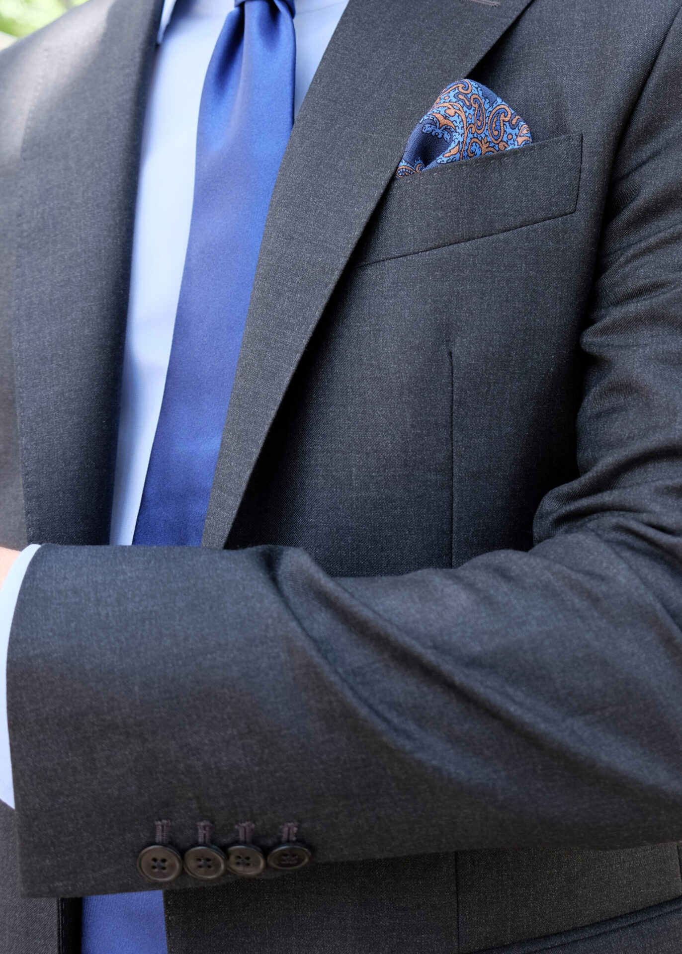 A close up of a person wearing a suit and tie