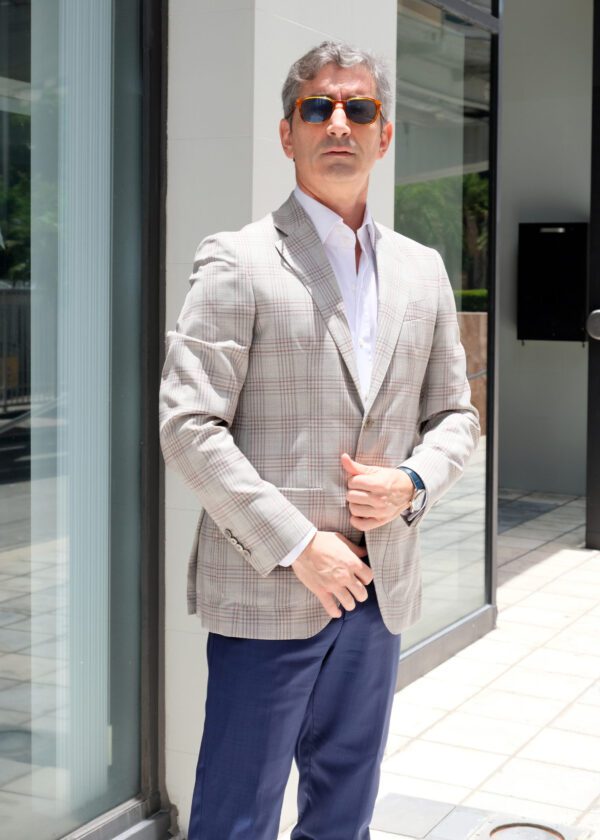 A man in a suit and tie standing outside.