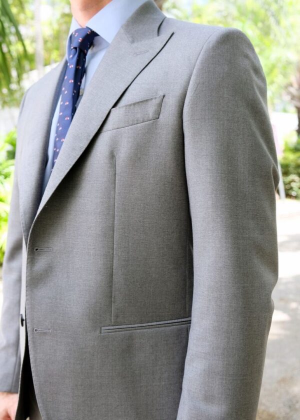 A man in a suit and tie standing outside.