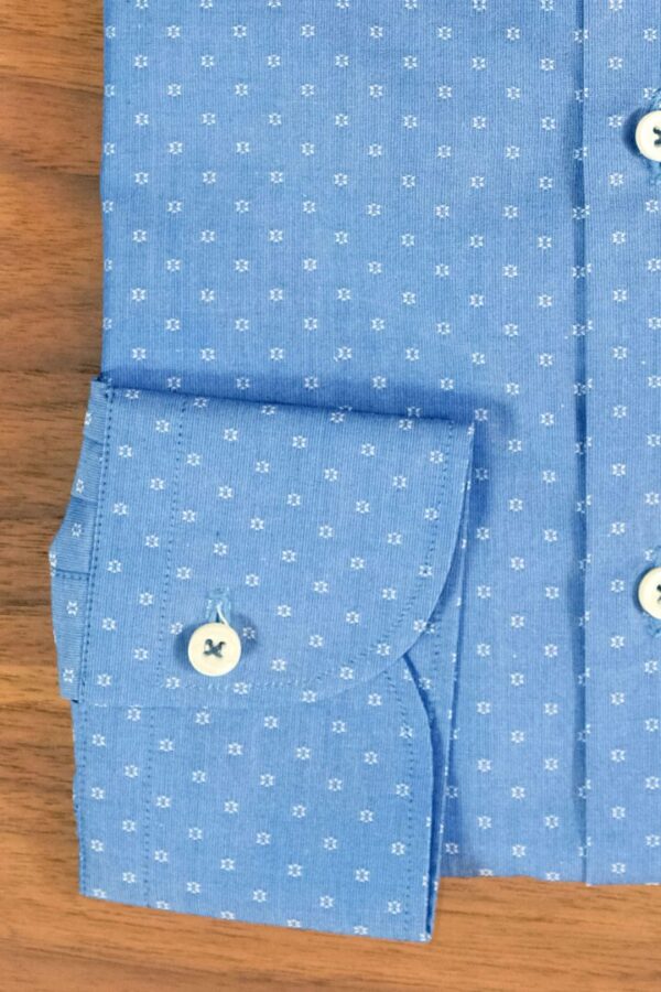 A close up of the buttons on a blue shirt