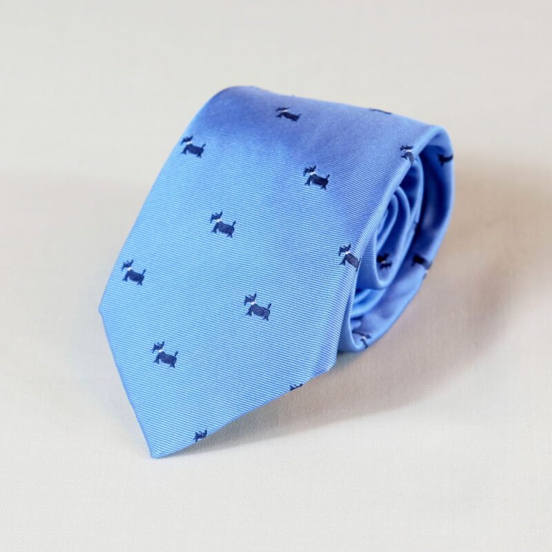 A blue tie with small black animals on it.