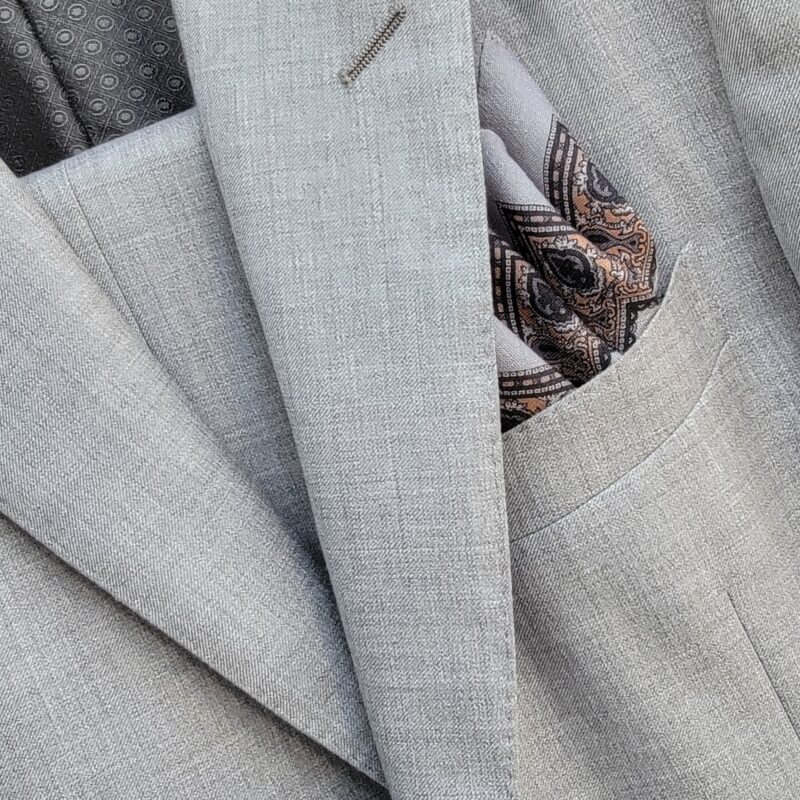 A close up of the pocket on a suit jacket