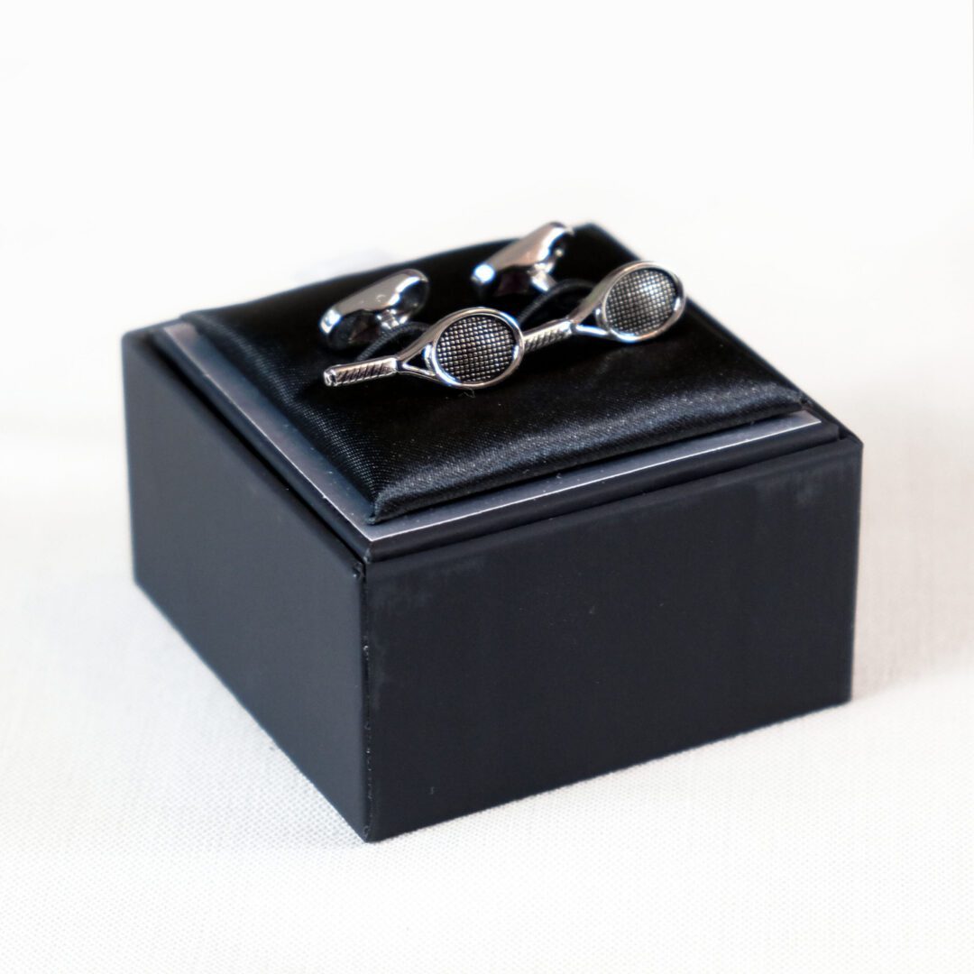 A black box with two pairs of cufflinks on top