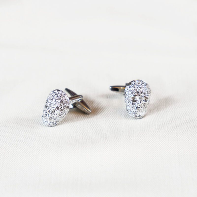 A pair of silver cufflinks with a diamond shaped design.