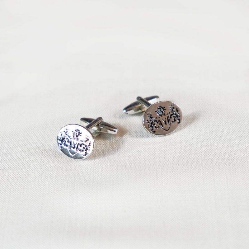 A pair of cufflinks with the word " luck " on them.