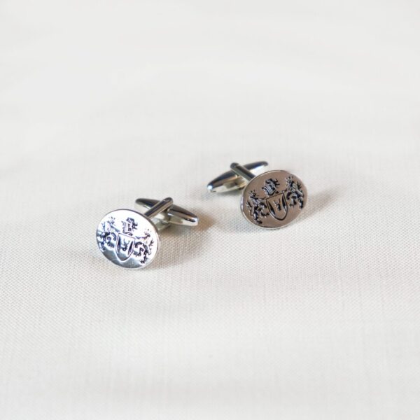 A pair of cufflinks with the word " love " on them.