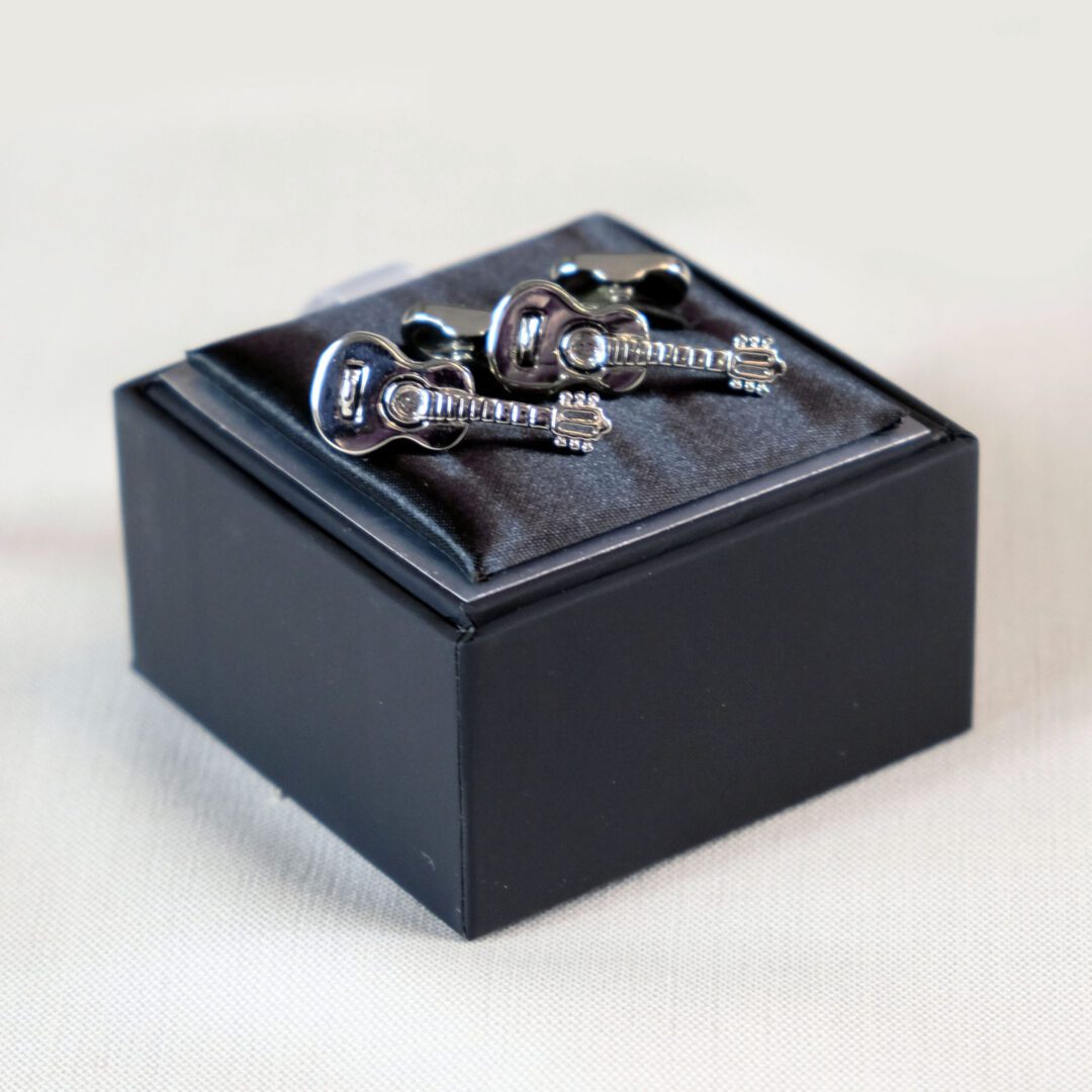 A pair of skull and crossbones cufflinks in a box.