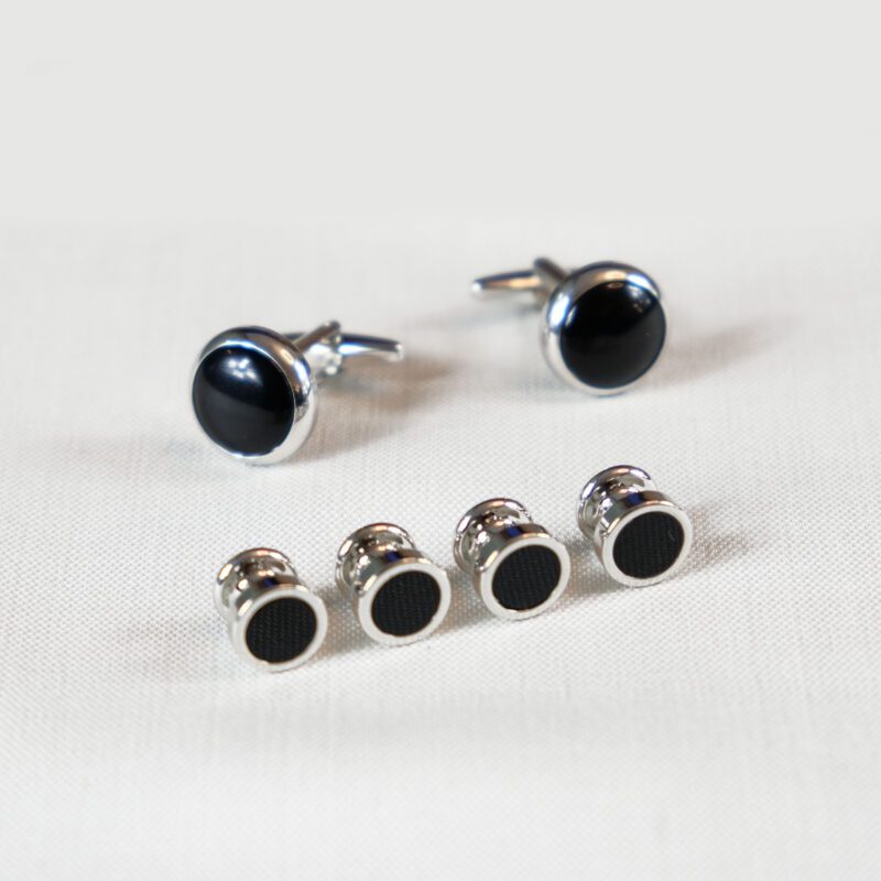 A set of four pairs of black and silver studs.