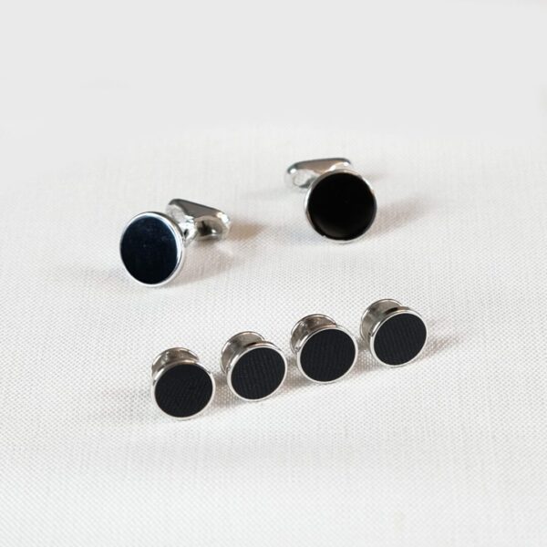 A set of six black and silver cufflinks.