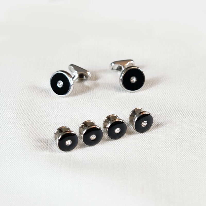 A set of six black and silver cufflinks.