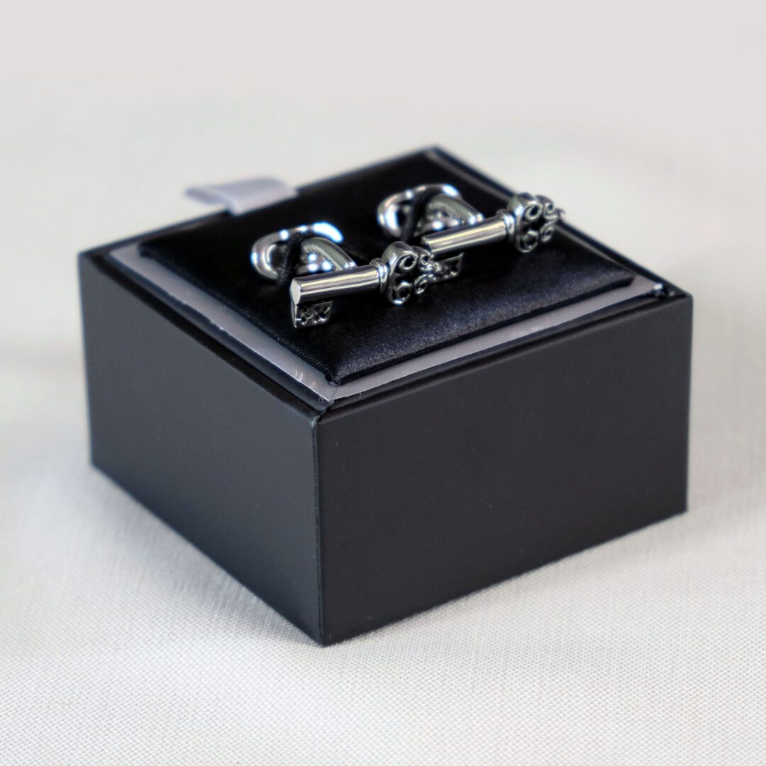 A black box with a pair of cufflinks in it