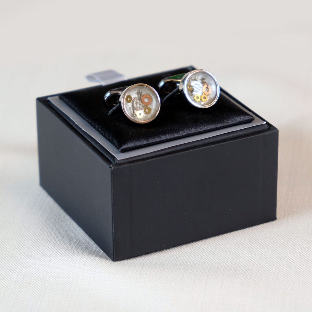 A pair of cufflinks in a black box.