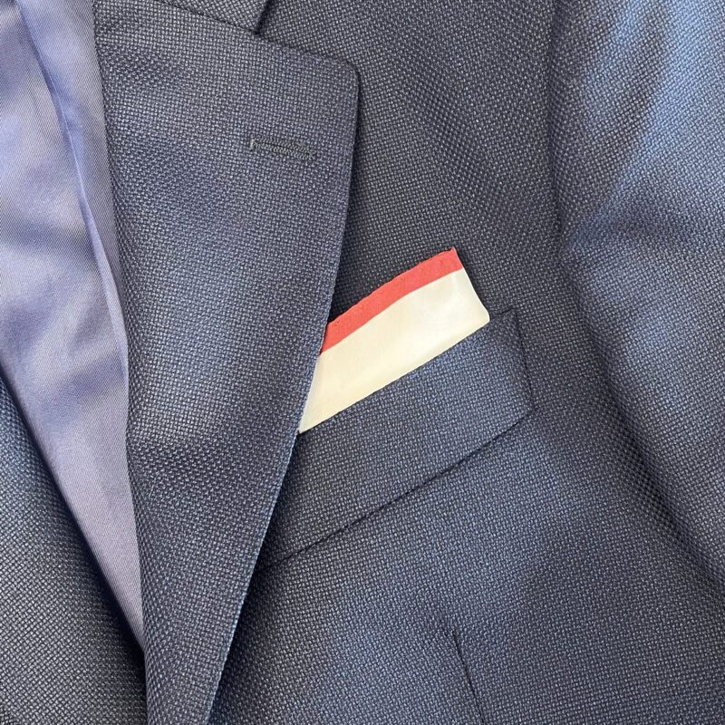 A close up of the pocket square on someone 's suit
