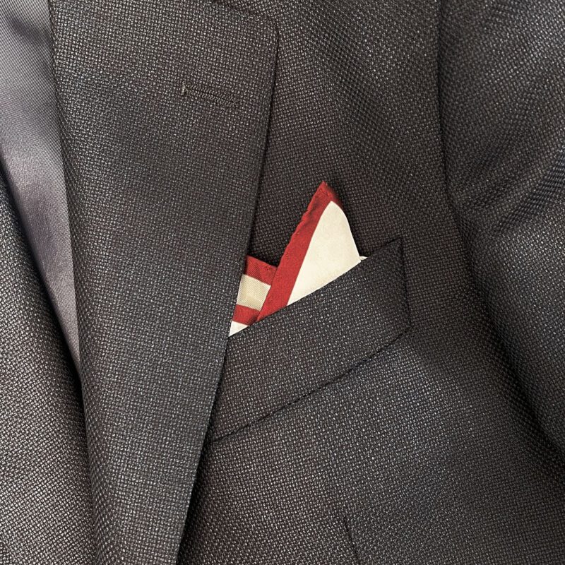 A close up of the pocket square in someone 's suit