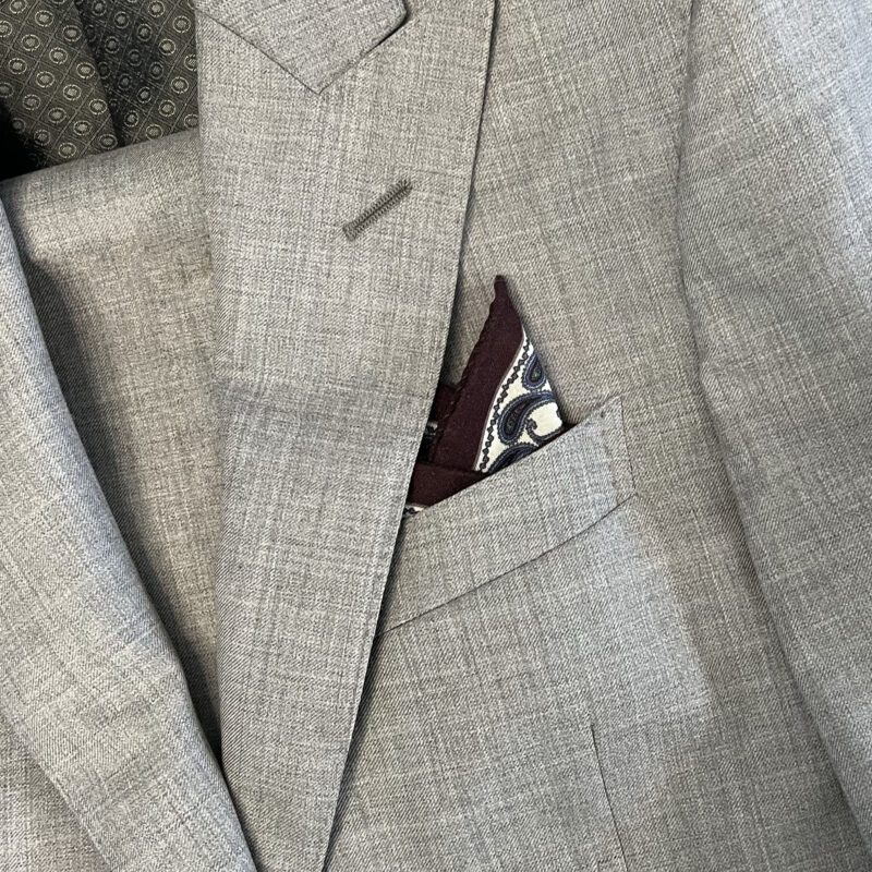 A suit jacket with a pocket square on it.