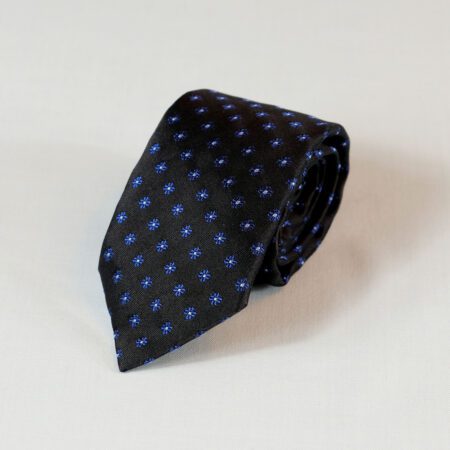 A black tie with blue polka dots on it