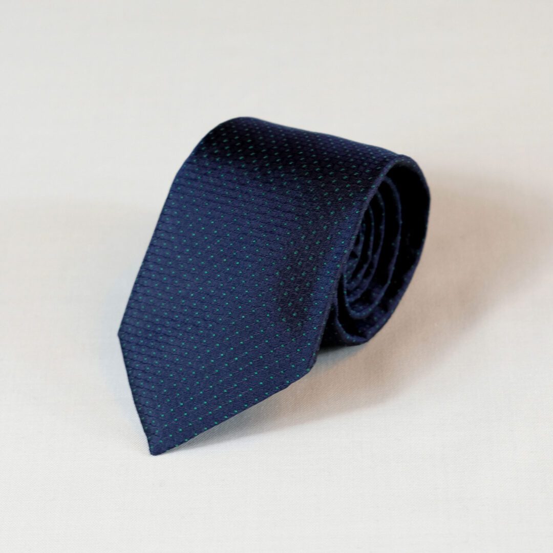 A blue tie is laying on the table