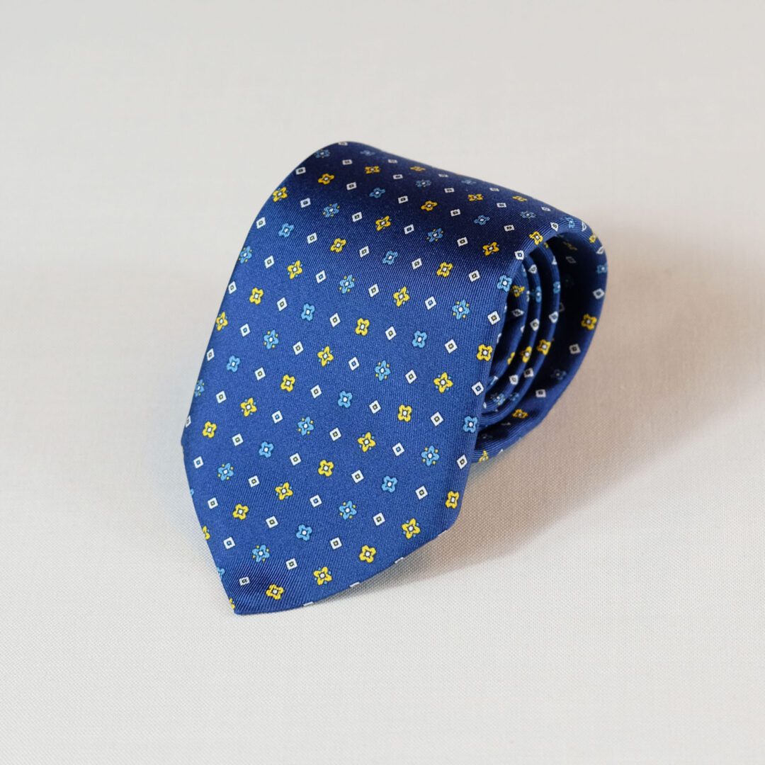 A blue tie with yellow dots on it
