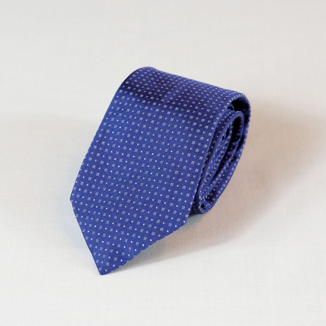 A blue tie with white squares on it.