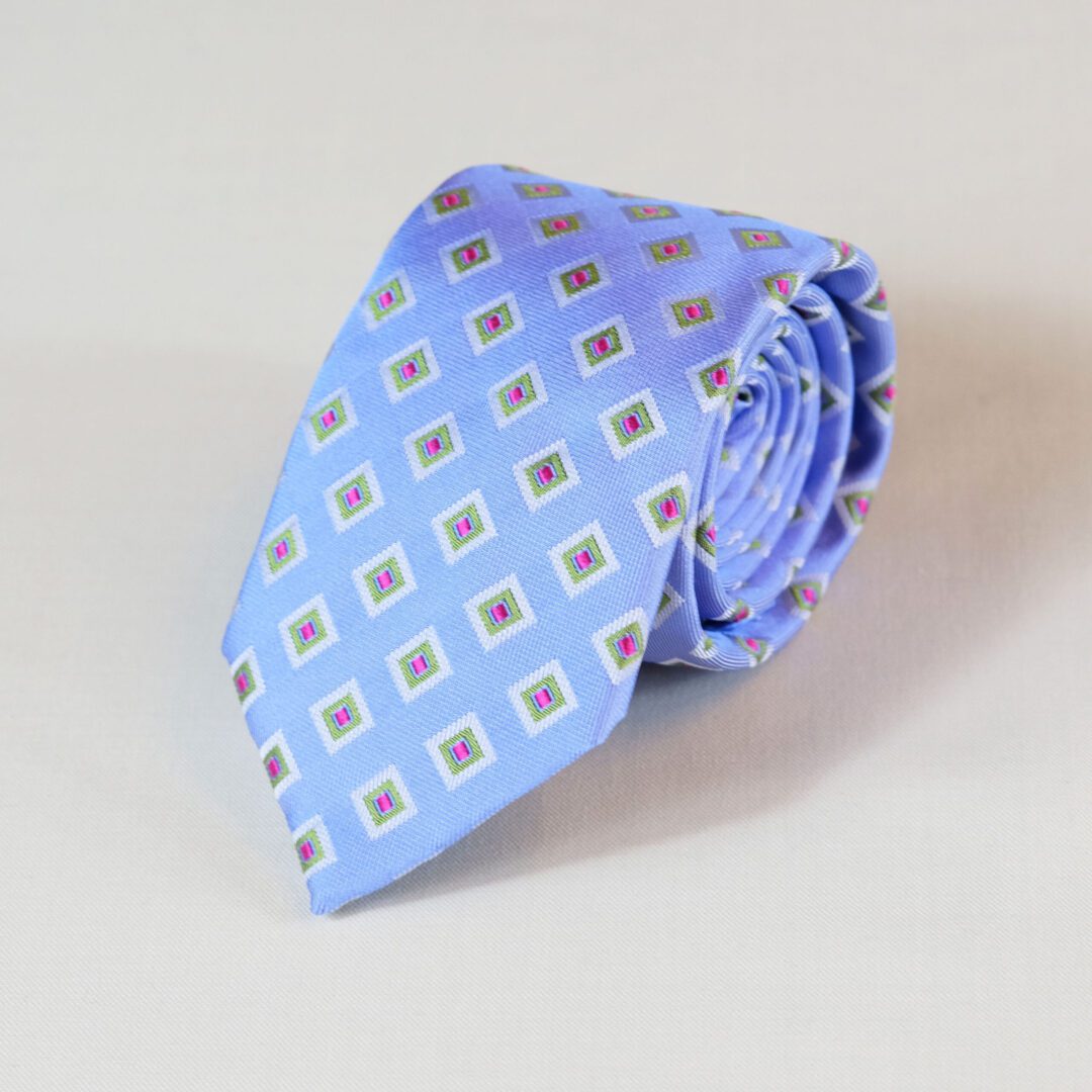 A blue tie with brown squares on it