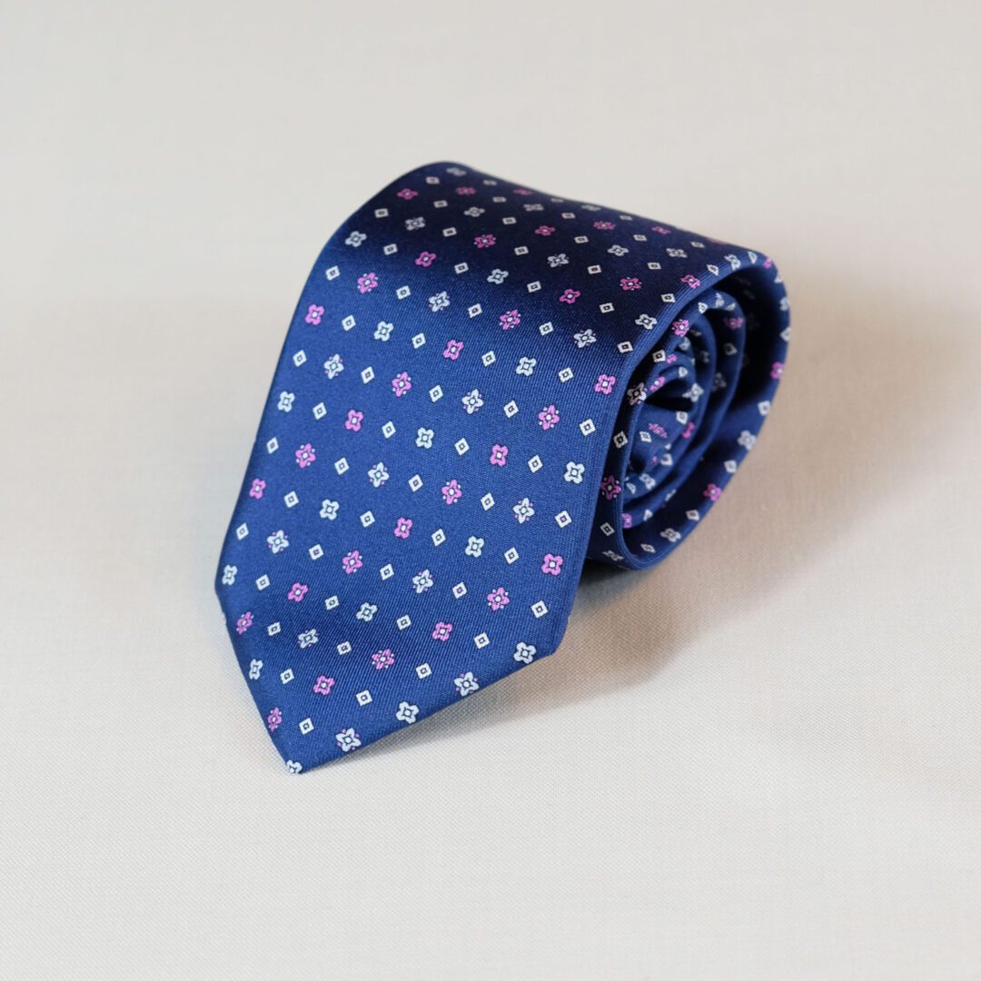 A blue tie with white and pink polka dots.