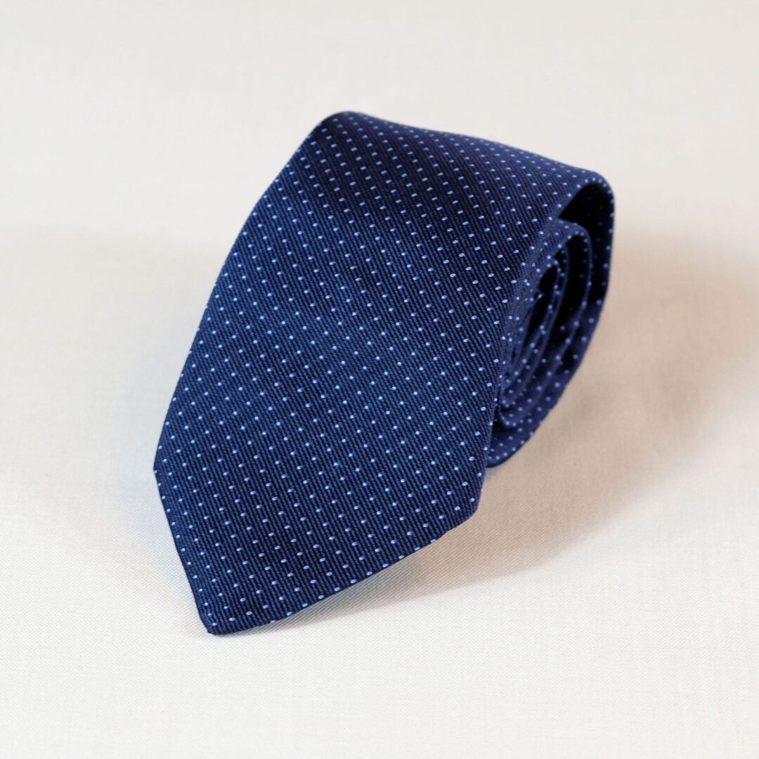 A blue tie with white dots on it