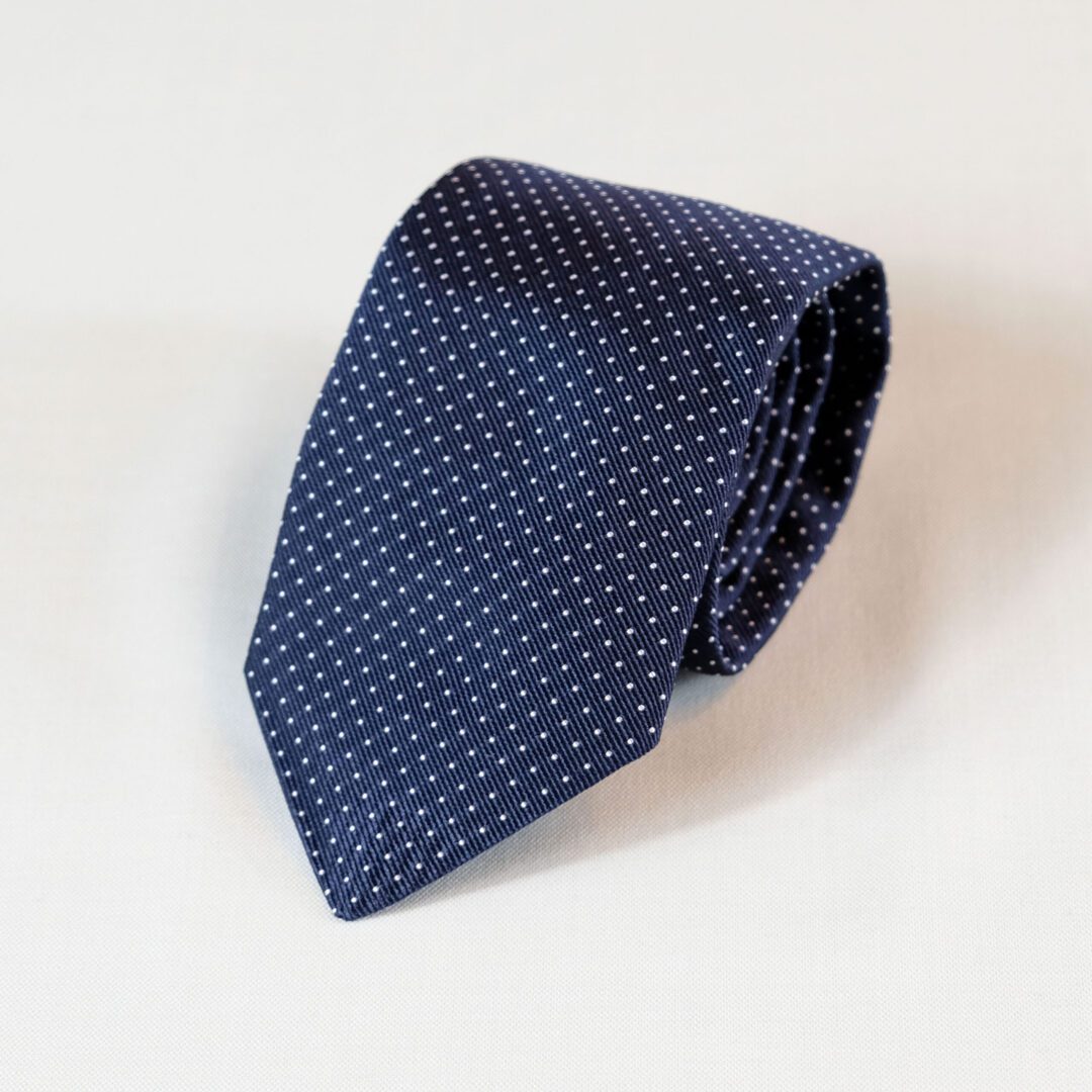 A blue tie with white dots on it