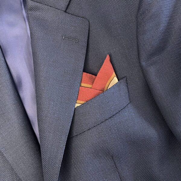 A close up of the pocket square in someone 's suit