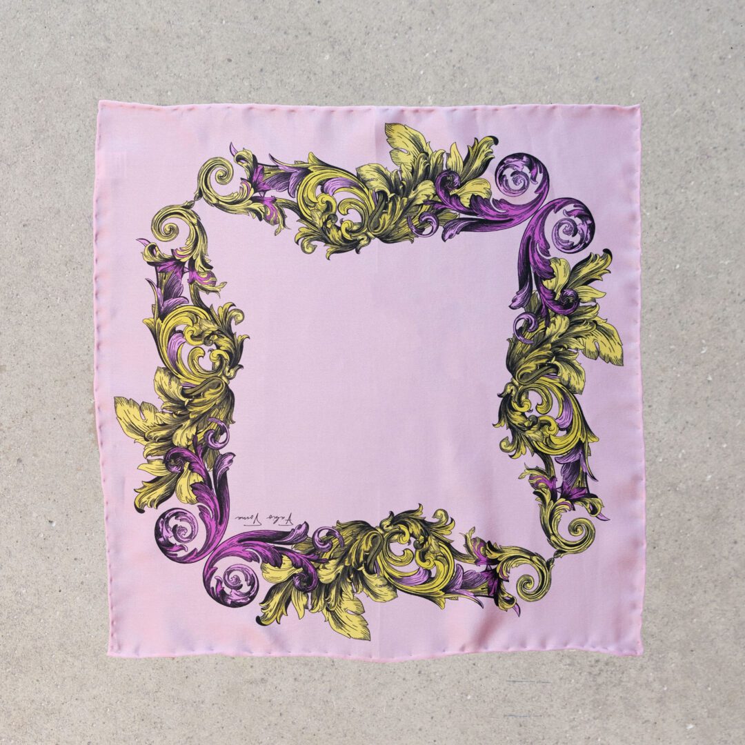 A purple and green scarf with flowers on it.