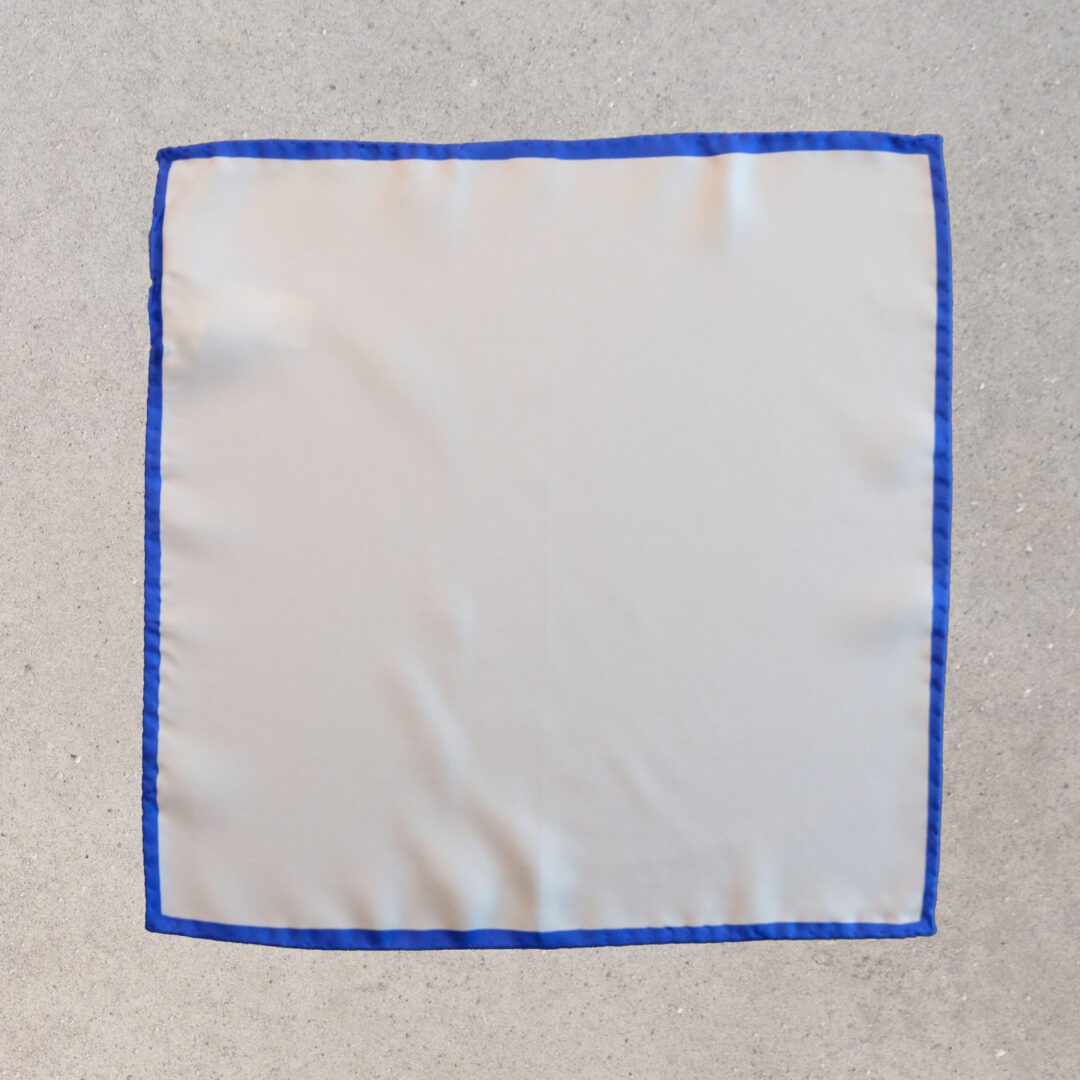 A white cloth with blue trim on the corner.