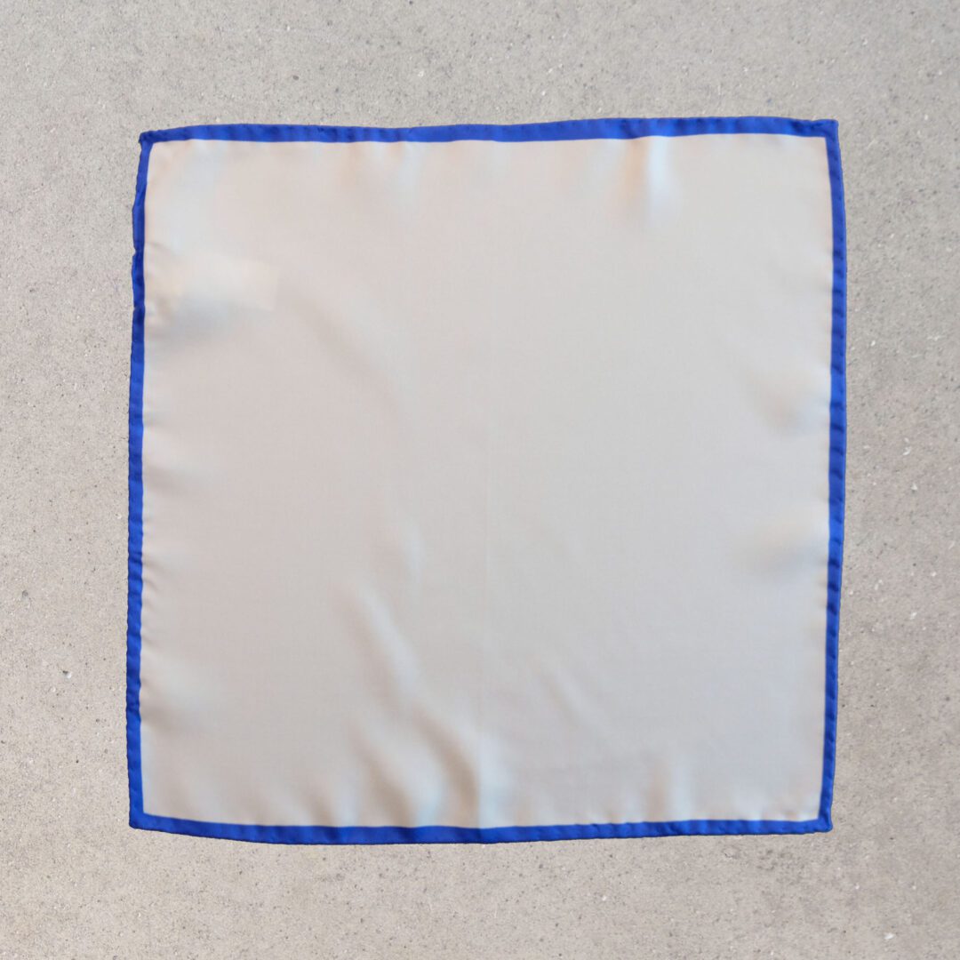 A white cloth with blue trim on the edge of it.