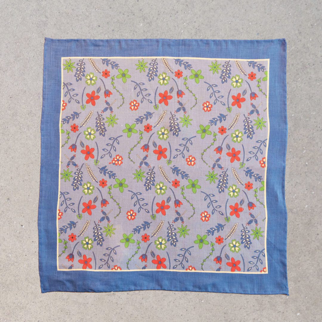 A blue and white floral scarf with a blue border.