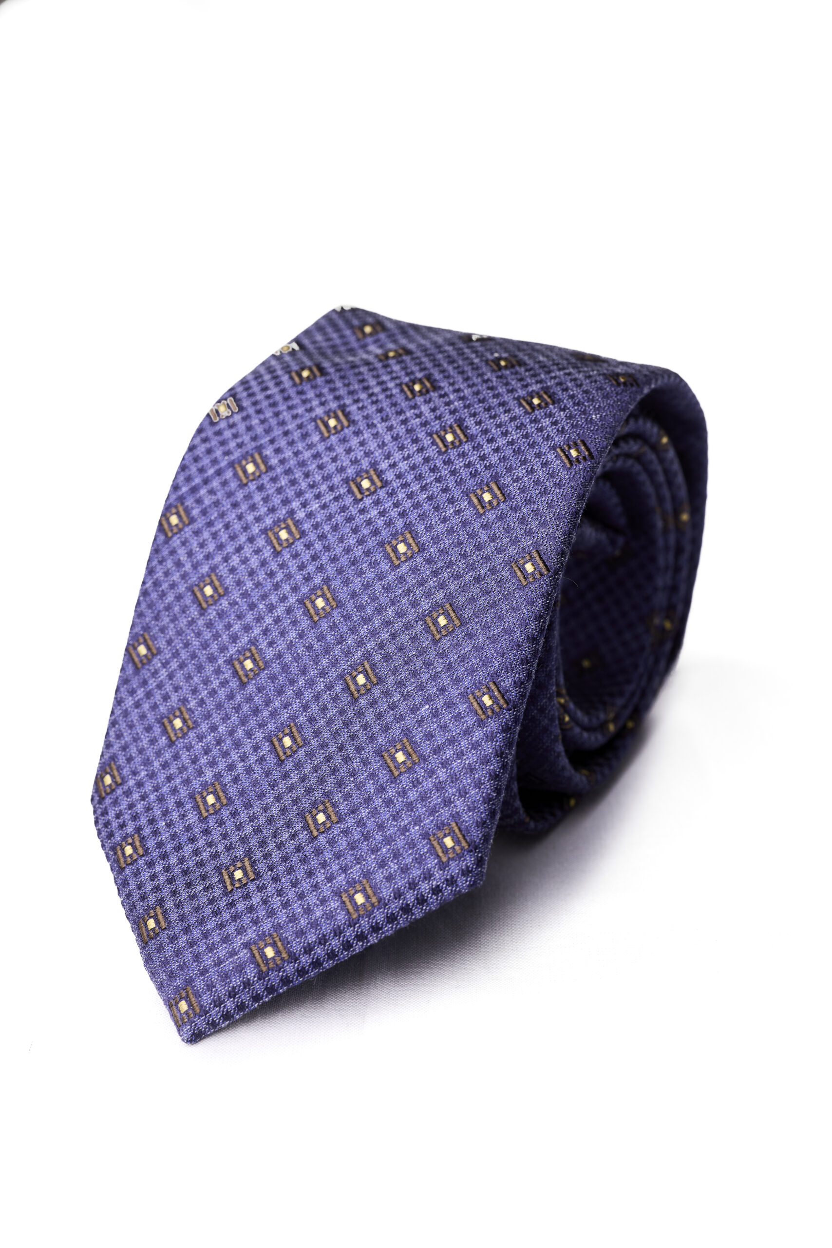 A purple tie with brown squares on it