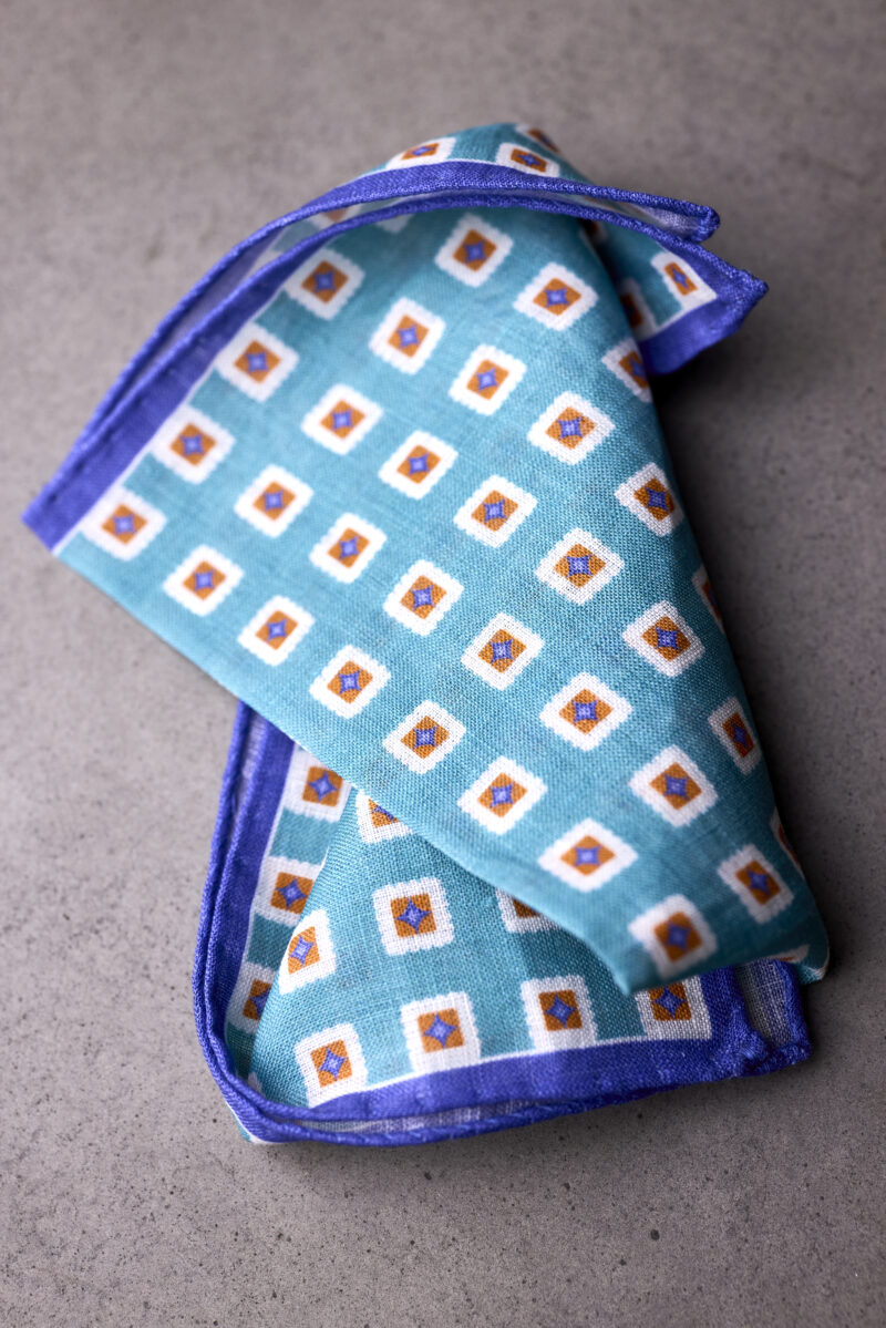 A blue and white square patterned pocket square