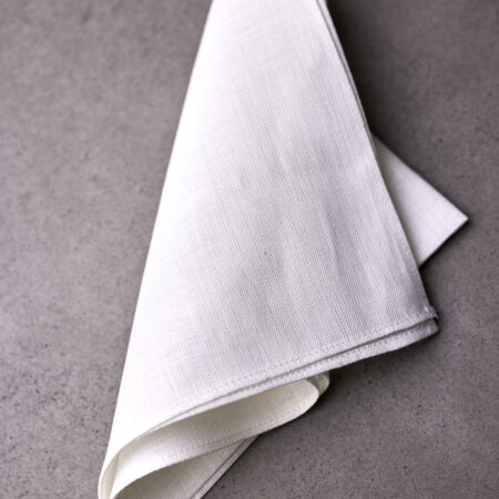 A folded white napkin on top of a table.