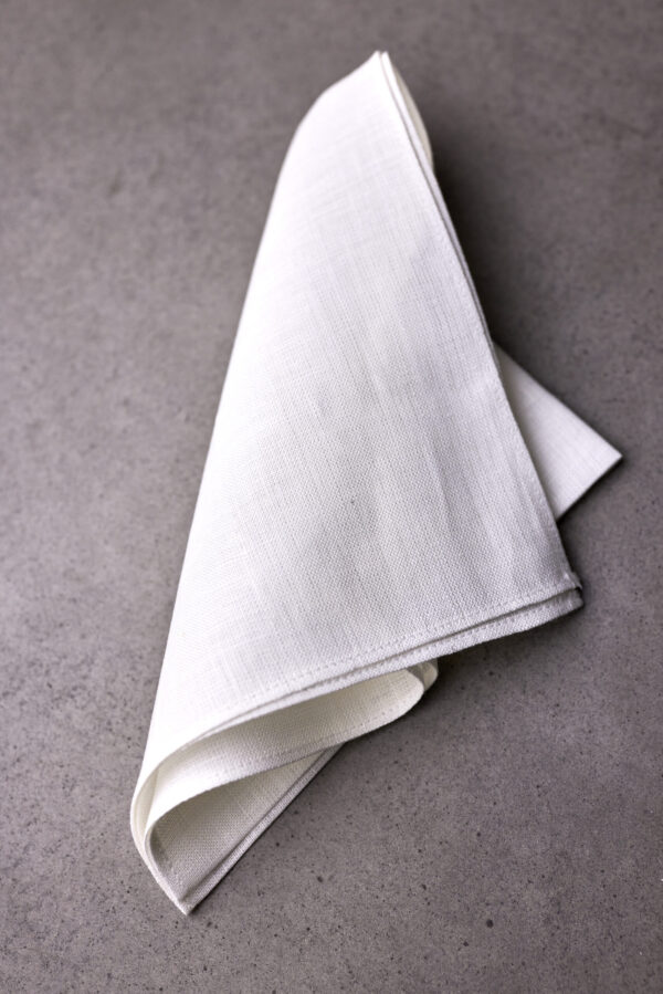 A folded white cloth on top of a table.