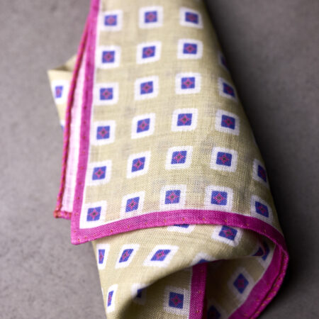 A folded cloth with purple and white squares on it.