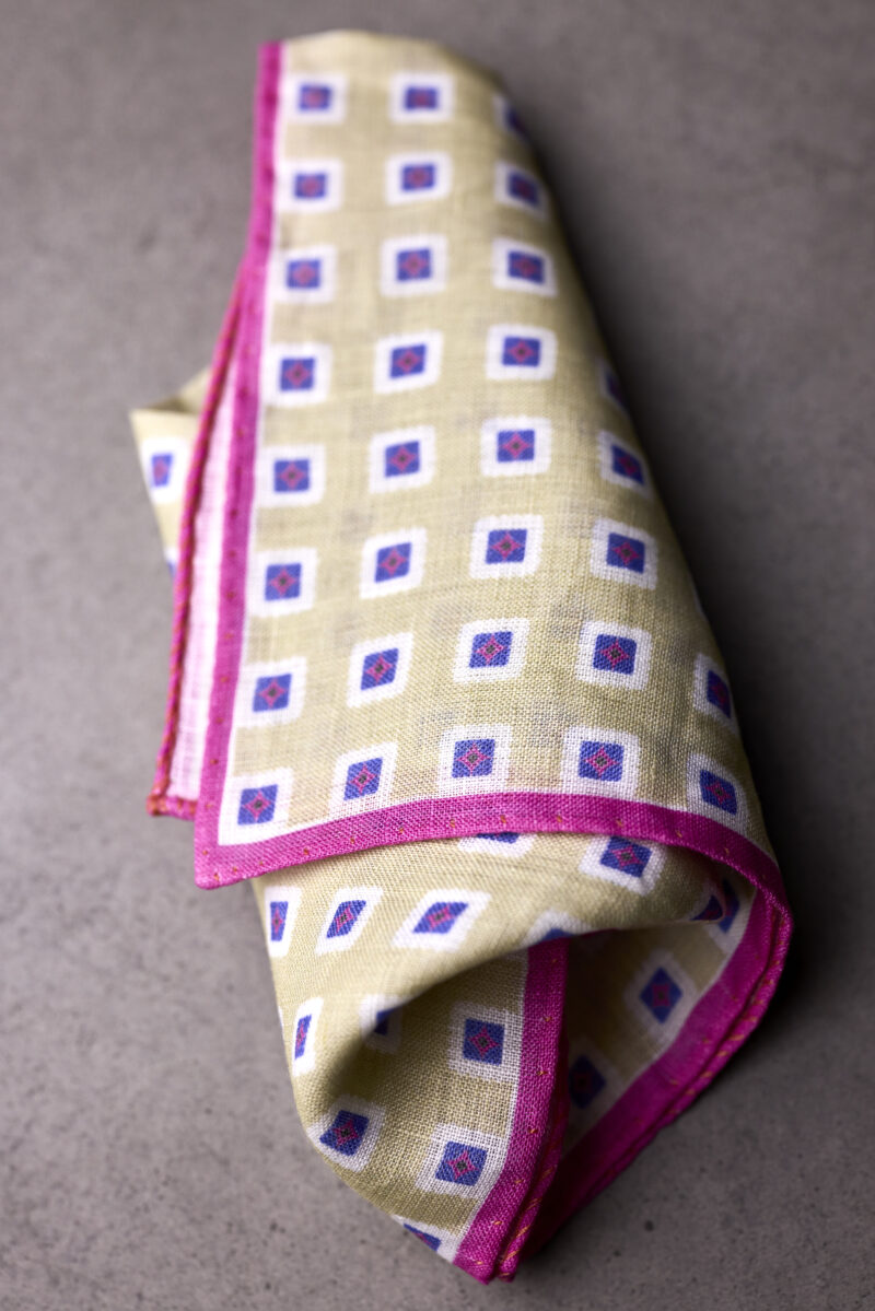 A folded cloth with purple and white squares on it.