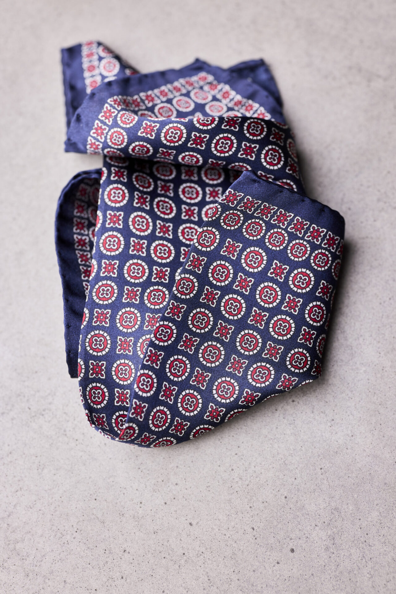 A folded blue and red patterned pocket square.