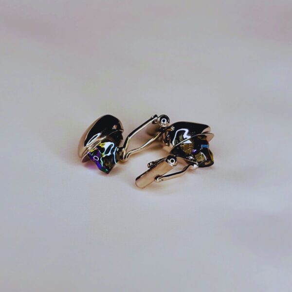 A pair of earrings sitting on top of a table.