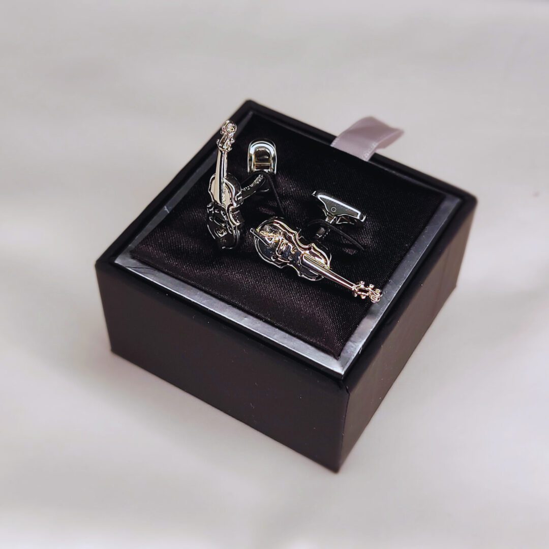 A silver figurine of a man in a box.