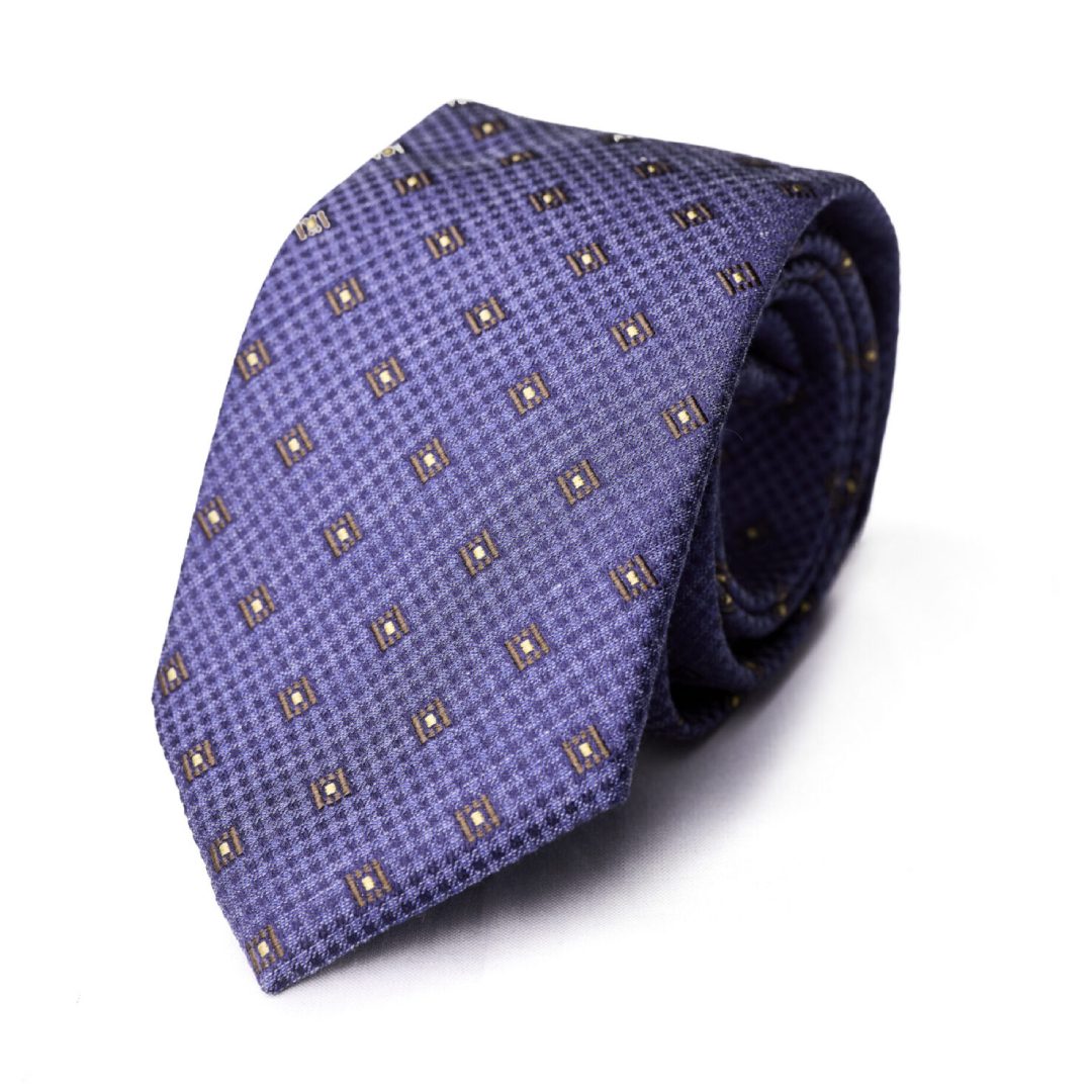 A purple tie with brown and white squares on it.